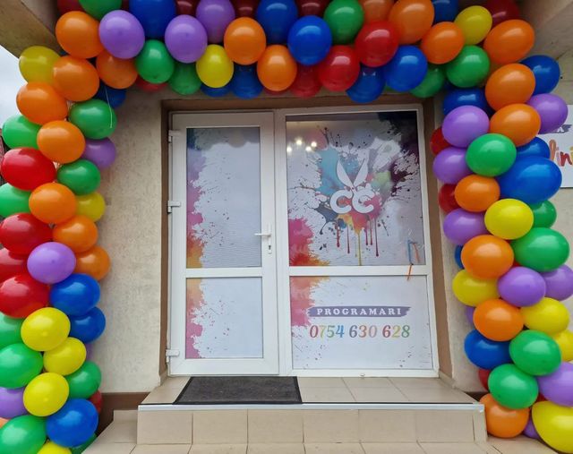 Intrarea în frizerie, decorată cu un arc de baloane colorate